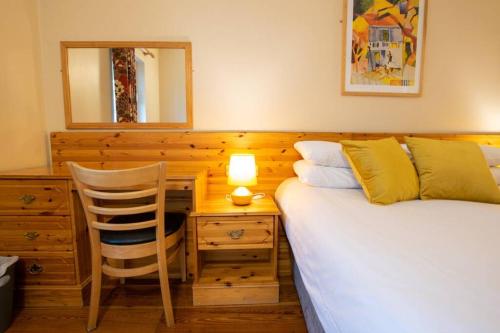 a bedroom with two beds and a desk and a chair at 310 - The Carrowbeg at The Harbour Mills by Shortstays in Westport