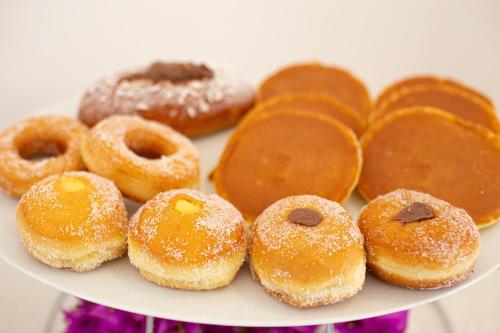 a plate of donuts sitting on a table at La Corte Di Pulicinu in Baja Sardinia