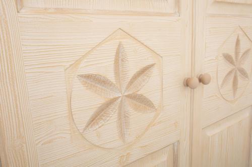 a wooden door with a flower painted on it at La Corte Di Pulicinu in Baja Sardinia