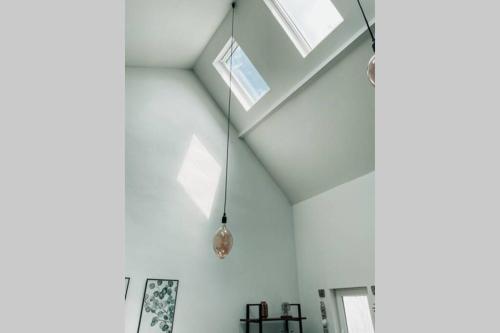 a room with white walls and skylights at Ganze Wohnung - schönes und helles Loft in Kreuzau in Kreuzau