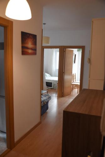 a living room with a bed and a room with a hallway at A pie de playa en Suances in Suances