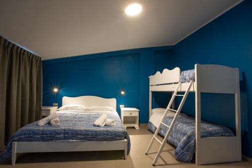 a bedroom with blue walls and a bunk bed at Le Coccole in Guardiaregia