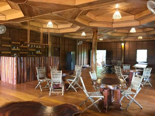 a room with chairs and a table in it at Gibbon Lodge in Senmonorom