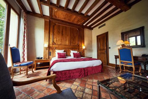 a bedroom with a large bed in a room at Relais Bernard Loiseau in Saulieu