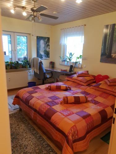 a bedroom with two beds and a desk and a chair at Luxus Ferienwohnung in Pfungstadt