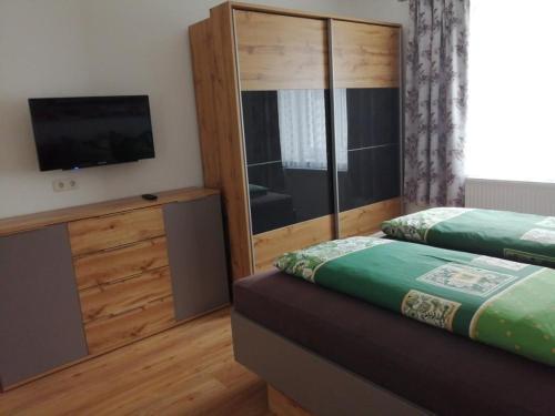 a bedroom with two beds and a flat screen tv at Wohlfühlhof Bachzelt in Weitersfeld
