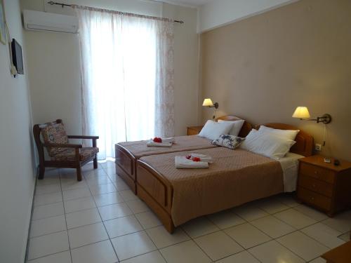 a bedroom with a bed with two towels on it at Stella Studios in Argasi
