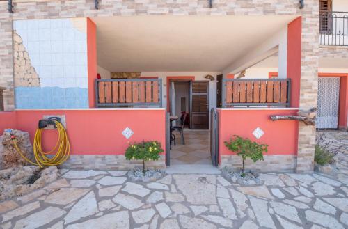 a house with red walls and a patio at A Casa di Amy in Macari