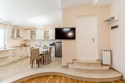 a kitchen and dining room with a table and chairs at Dat Exx Apartments On Liberty Square in Tbilisi City