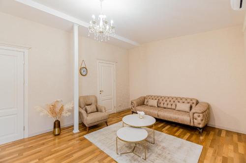 a living room with a couch and a table at Dat Exx Apartments On Liberty Square in Tbilisi City