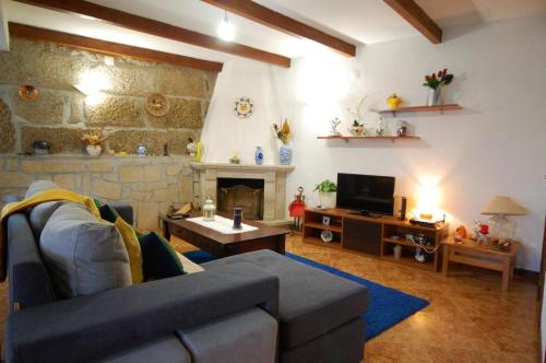 a living room with a couch and a fireplace at Casa da Ramada - Water SPA Tank with running natural spring water - by Bedzy in Braga