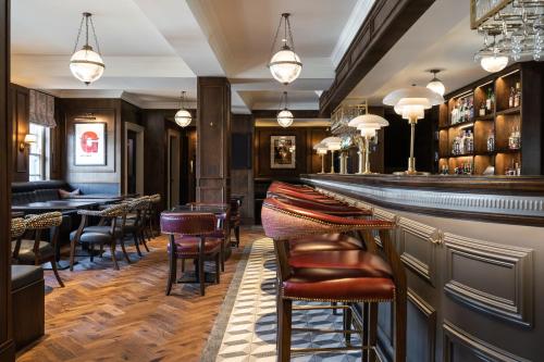 a bar with chairs and tables in a restaurant at The Cuan Boutique Hotel in Strangford