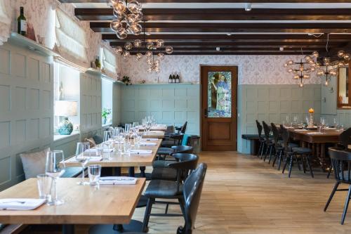 a row of tables and chairs in a restaurant at Hotel Heiligenstein in Baden-Baden