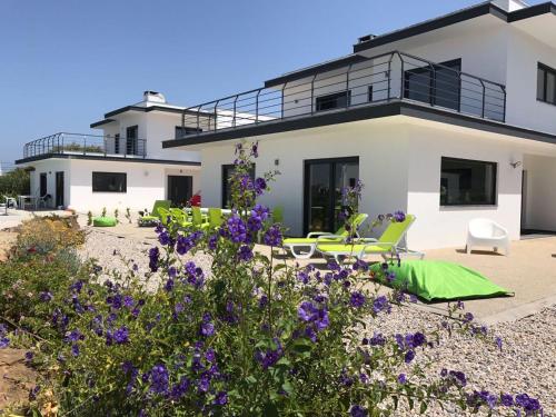 a house with purple flowers in front of it at Casa Verde in Feteira