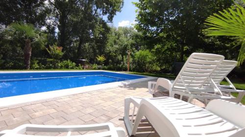 a pair of chairs and a swimming pool at Apartman Natura vita Blagaj in Blagaj