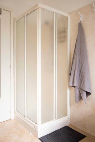 a white cabinet with a towel hanging on it at Cloud 9 - Apartment with stunning lake view in Belgirate