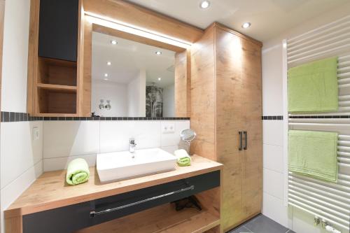 a bathroom with a sink and a mirror at Ferienwohnungen Brigitte in Oberstdorf