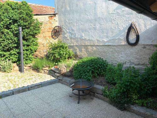 a patio with a table in front of a building at Penzion Na Růžku in Sedlčany