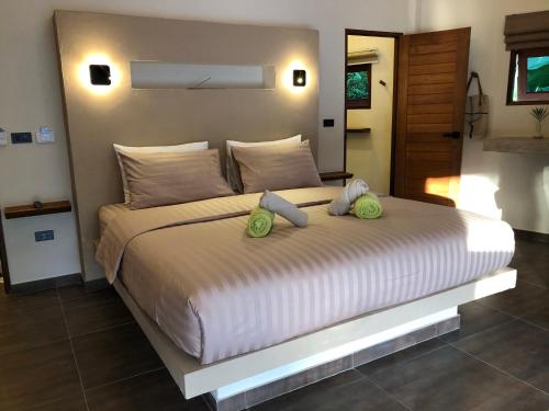 a bedroom with a large bed with two pillows on it at Baan Taolili villa 3 bedrooms in Hinkong