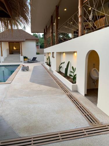 an external view of a house with a swimming pool at Baan Taolili villa 3 bedrooms in Hinkong
