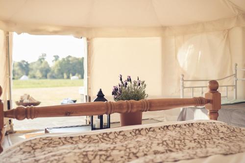 a bedroom with a bed with a view of a window at Home Farm Glamping in Elstree