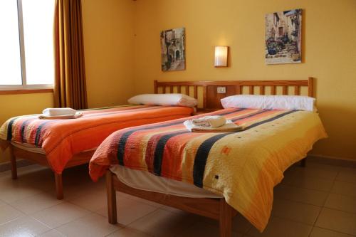 A bed or beds in a room at Casa MARA Tenerife