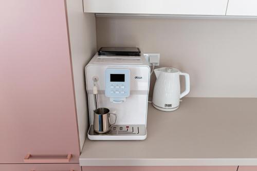 a coffee maker sitting on a shelf in a kitchen at Apartament Bella Rosa z podziemnym parkingiem in Kielce