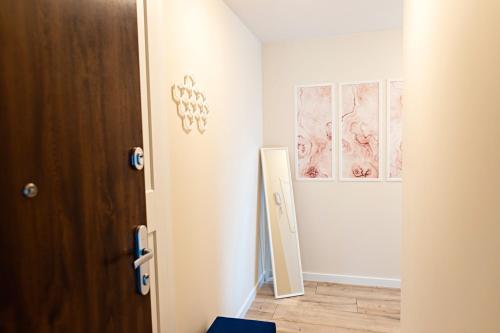 a door to a room with drawings on the wall at Apartament Bella Rosa z podziemnym parkingiem in Kielce