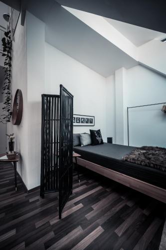 a bedroom with a bed and a white wall at Sommers Hotel Altes Posteck in Reichenbach im Vogtland