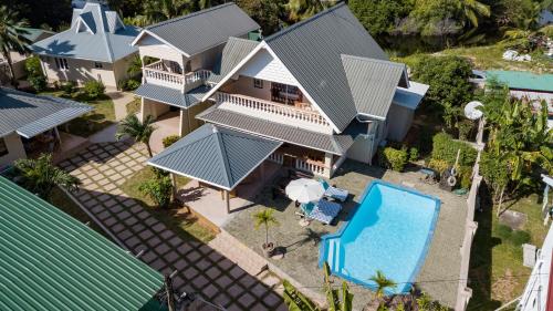an aerial view of a house with a swimming pool at Villa Aya in Grand'Anse Praslin