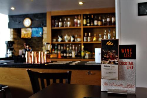 a bar with a counter with bottles of alcohol at The Portcullis in Bristol