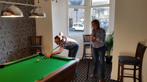 a man and a woman playing a game of tennis at The Portcullis Hotel in Bristol