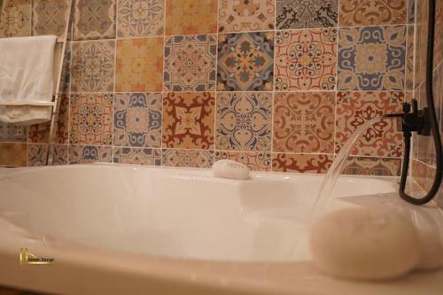 a bathroom with a bath tub with a faucet at تاج عكا Taj Akko in &lsquo;Akko