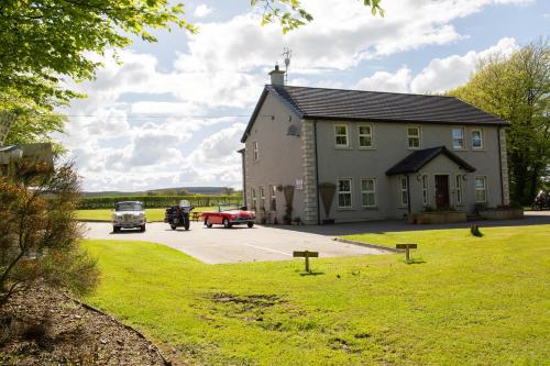 a large house with cars parked in front of it at Groarty House/Manor in Derry Londonderry