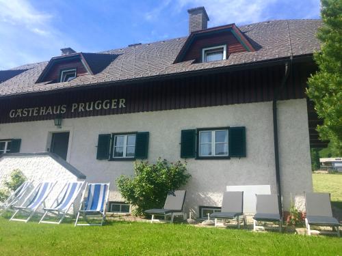 a group of chairs sitting in front of a building at Gästehaus Prugger by Schladmingurlaub in Ramsau am Dachstein