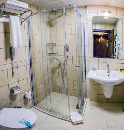 a bathroom with a shower and a sink at Yucelen Hotel in Akyaka