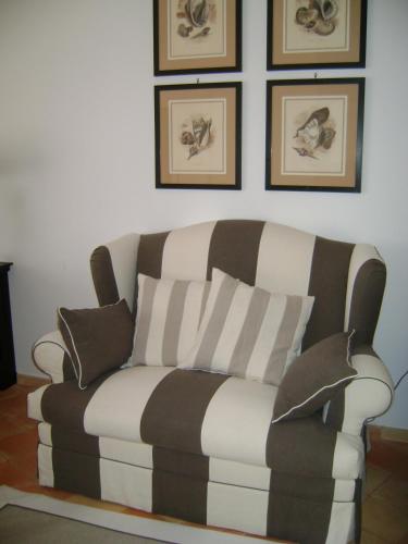 a couch sitting in a living room with pillows at Covo Dei Saraceni in Positano