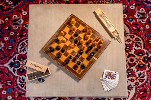 a wooden chess board sitting on top of a table at Wooden Barn in Zăbala