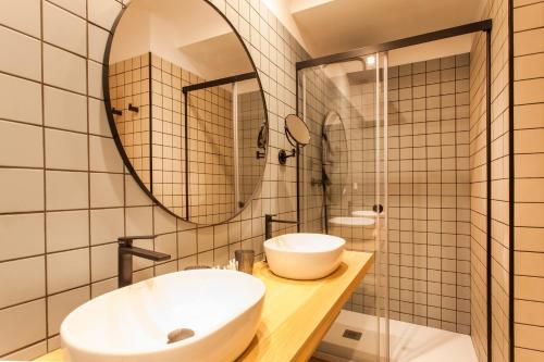 a bathroom with a sink and a mirror at Hospedium H Cabo Sport in Finisterre