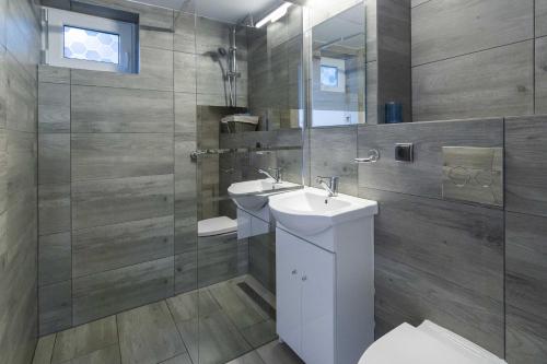 Un baño con inodoro, lavabo y ducha. en Gniazdo. Apartamenty, pokoje, en Jastrzębia Góra