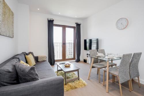 a living room with a couch and a table at Top Floor Luxury 2 Bedroom St Albans Apartment - Free WiFi in St. Albans