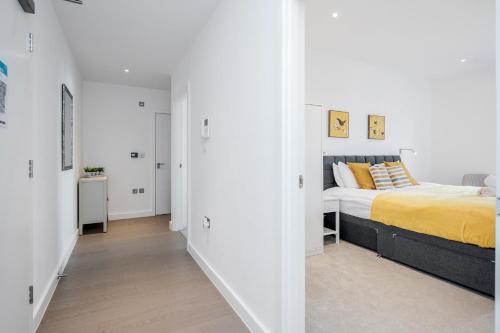 a bedroom with a bed and a hallway at Top Floor Luxury 2 Bedroom St Albans Apartment - Free WiFi in Saint Albans