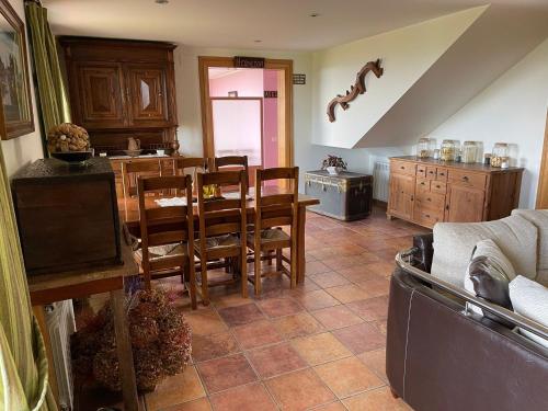 a kitchen and dining room with a table and chairs at LA CASONA DE RALES VILLAVICIOSA in Rales