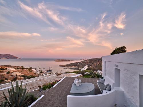 a white house with a view of the ocean at The Windmill Kimolos in Kimolos