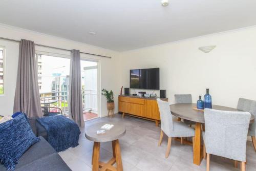 a living room with a couch and a table at Inner City One Bedroom Apartment 27 in Cairns