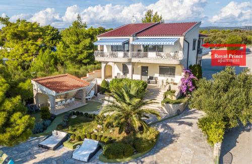 an aerial view of a house with a palm tree at Apartments Villa Punta Royal in Pirovac