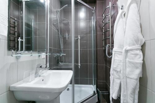 a bathroom with a sink and a toilet and a shower at Apart 64 Guest House in Krasnaya Polyana