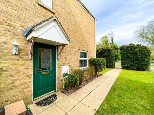 a brick house with a green door and a sidewalk at Kings Quarters Boutique Rooms in Hartford