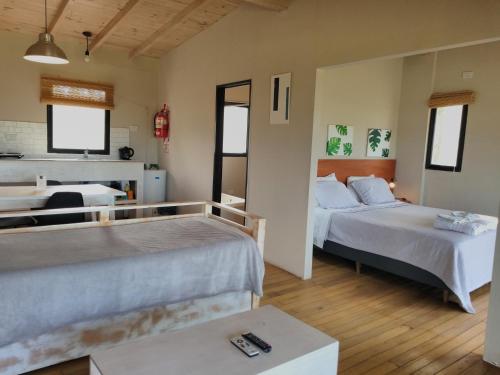 a hotel room with two beds and a table at Cabañas Norden San Pedro in San Pedro