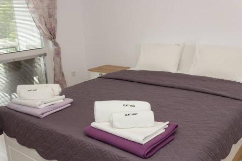 a bedroom with a bed with towels on it at Perfect Summer Vacation Rental - One-Bedroom Flat in Topola